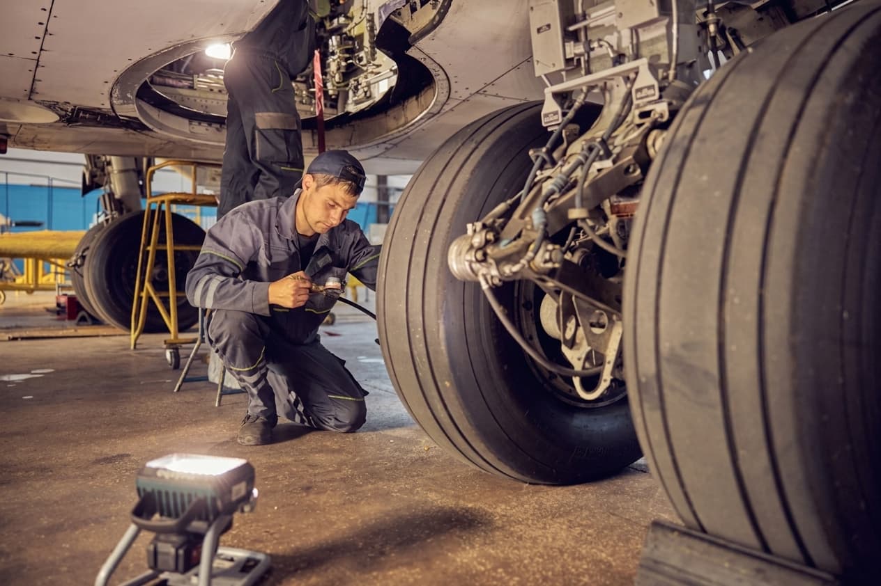 Technician working on an aircraft engine